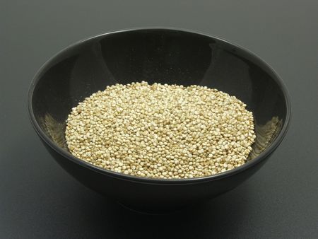 Bowl of chinaware with quinoa on a dull mattingの写真素材