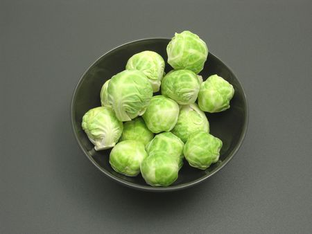 Bowl of chinaware with brussels sprouts on a dull mattingの写真素材