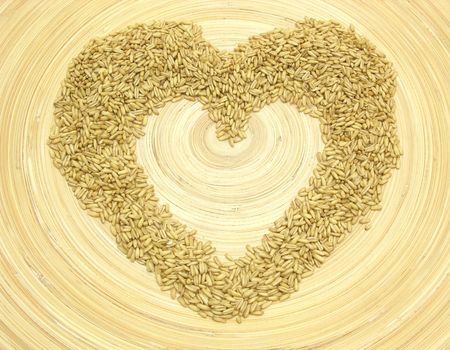 Bamboo plate with heart out of grain の写真素材