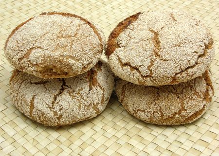 Home made wholemeal vinschgauer buns on rattan underlay