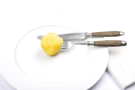Peeled potato on tableの写真素材
