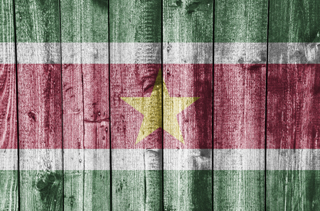 Flag of Suriname on weathered woodの写真素材