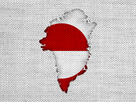 Map and flag of Greenland on old linenの写真素材