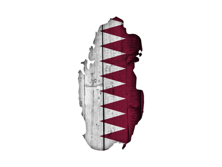 Map and flag of Qatar on weathered woodの写真素材