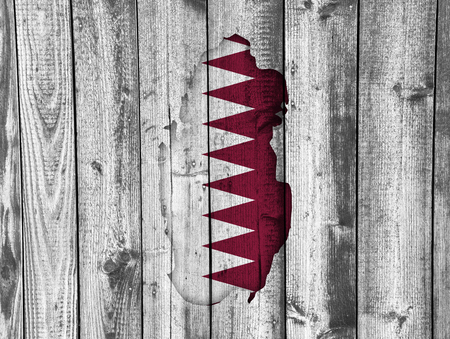 Map and flag of Qatar on weathered woodの写真素材