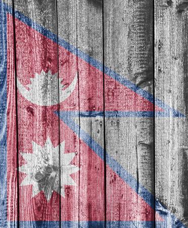 Flag of Nepal on weathered woodの写真素材