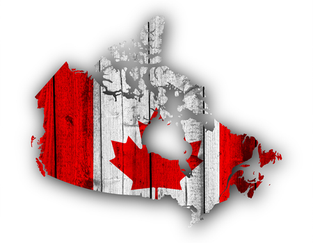 Map and flag of Canada on weathered woodの写真素材
