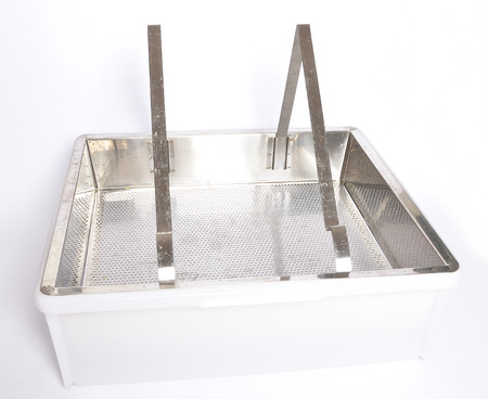 Plastic uncapping tub and sieve on white
