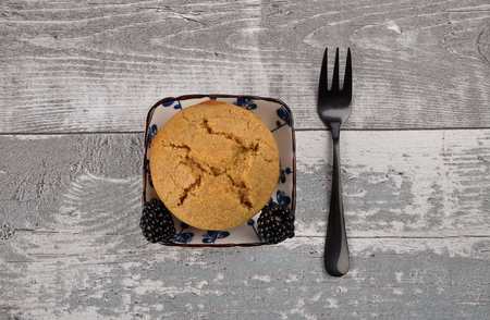 Muffin in bowl on weathered wood