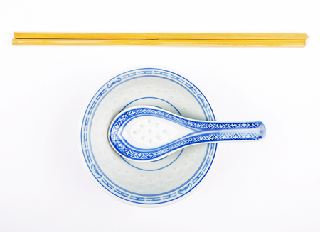 Asian dinnerware with cutlery on whiteの写真素材