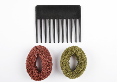 Comb and bobbles on white background