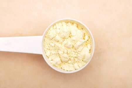 Lupin flour in measuring spoon on brown backgroundの写真素材