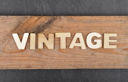 Term from wooden letters on grunge wood and shale