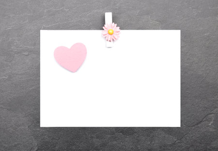 Chit and wooden peg on slate boardの写真素材