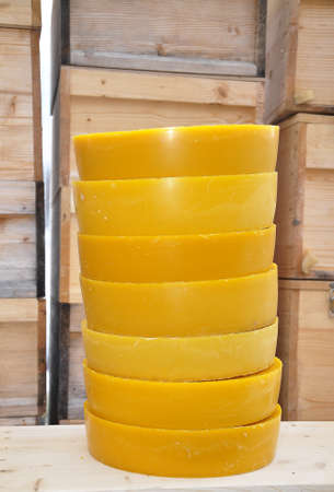 Round wax blocks in front of beehives in beekeepingの写真素材