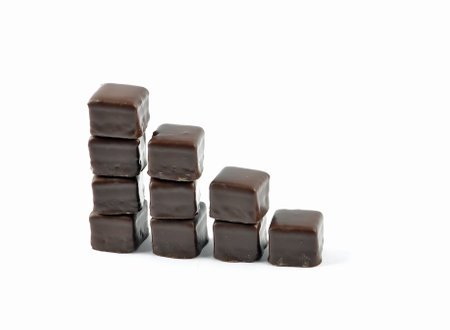 Dominosteine lined up in stacks on white backgroundの写真素材