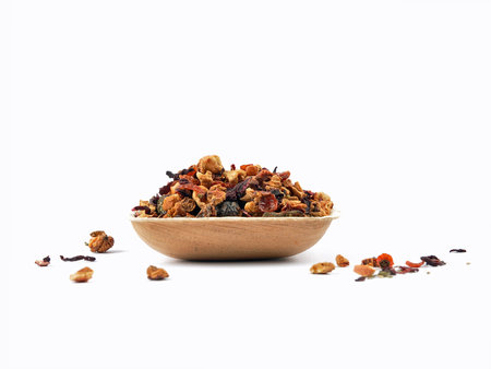Loose fruit tea in bamboo bowl on whiteの写真素材