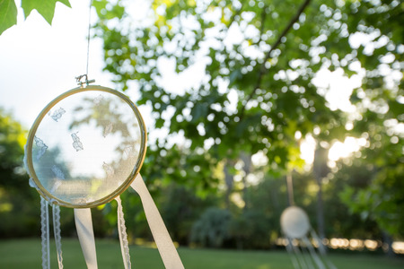 Lace Dream Catchers hang in a Garden in the Summer light