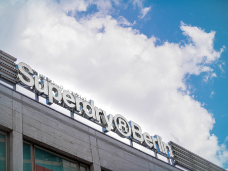 The signage for the Superdry store in Berlin with large cloudsのeditorial素材
