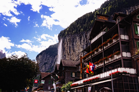 Lauterbrunnen, Switzerland - August 27, 2014 - Hotel Oberland and Other Buildings with Staubbach Falls in the Background in Tourist Town of Lauterbrunnen in Lauterbrunnen Valley, Jungfrau Region, Switzerlandのeditorial素材