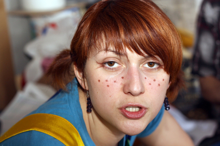young actress with imitation of freckles on her faceの写真素材