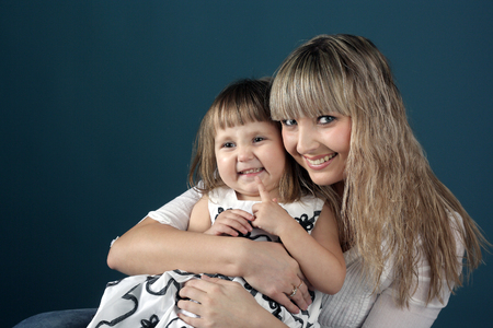 cute little child with young beautiful motherの写真素材