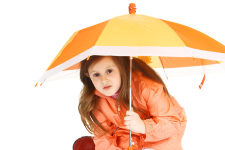 little child with the orange umbrellaの写真素材