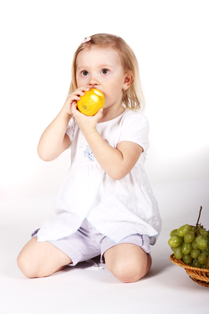 cute little child eating a lemonの写真素材
