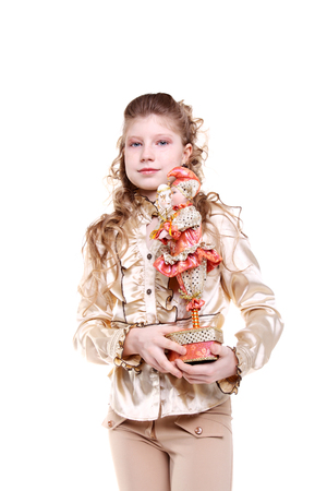 pretty little girl with a gift in her handsの写真素材