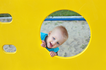 cute little child playing on the playground outdoorsの写真素材