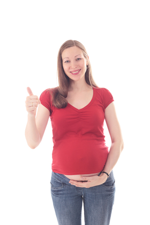 happy smiling young beautiful pregnant woman showing her thumb upの写真素材