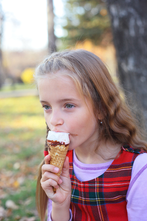 closeup image of the cute little girl eating the ice-creamの写真素材