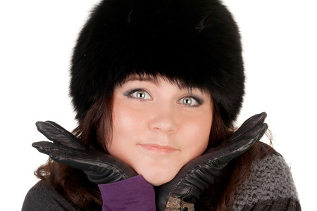 closeup image of the young smiling girl in the fur capの写真素材