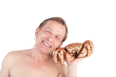 middle-aged smiling man with a big crabの写真素材
