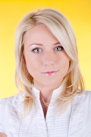 young blond girl on the yellow backgroundの写真素材