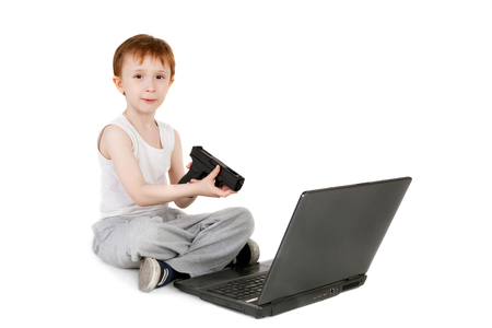 handsome little boy playing computer game with the pistolの写真素材