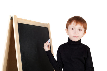 little boy writing on the blackboardの写真素材