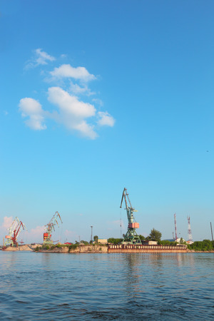 floating cranes over the river on the blue sky backgroundの写真素材