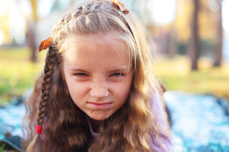 cute emotional little girl outdoors closeupの写真素材