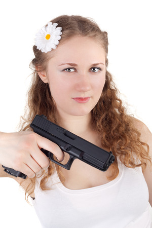 pretty young girl with the pistol in her handの写真素材