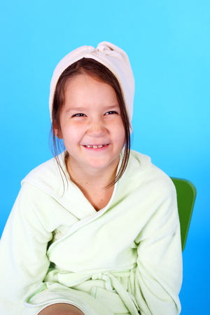 pretty little smiling girl in the bath robeの写真素材