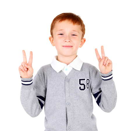 cute little boy showing the victory sign with his hands