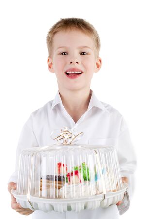 cute handsome smiling little boy holding the cakeの写真素材