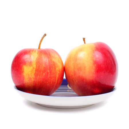 yellow and red apples on the plateの写真素材