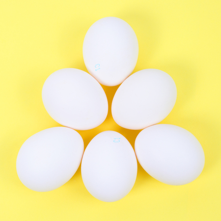 chicken eggs over yellow backgroundの写真素材