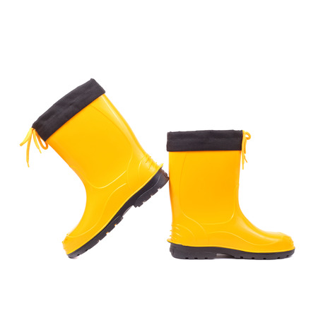 pair of the bright yellow rubber shoesの写真素材