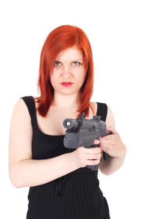 serious little girl with the pistol, focus on the pistolの写真素材