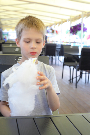 little boy with cotton candyの写真素材