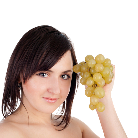 closeup image of the pretty young girl with the bunch of grapesの写真素材