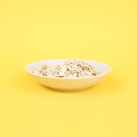 white plate of oats closeupの写真素材